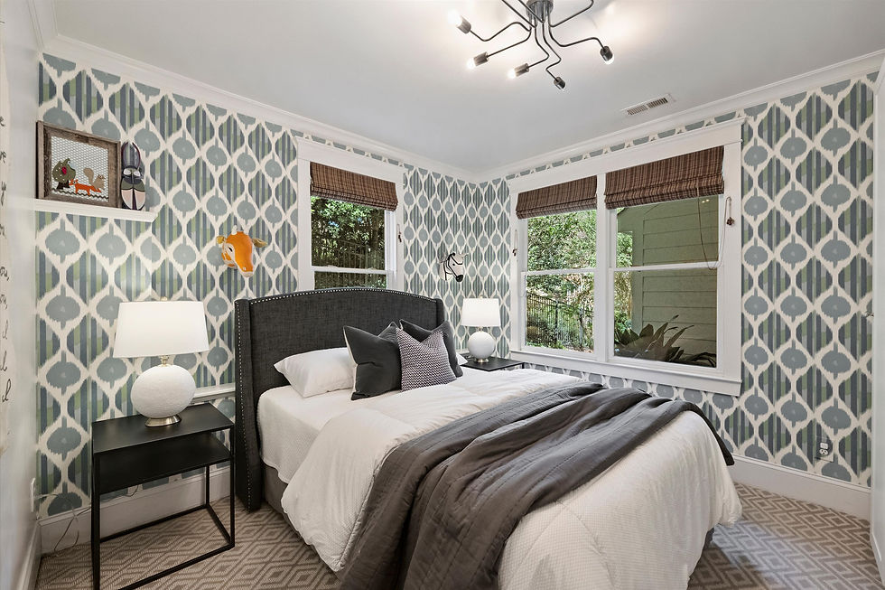 Bright patterned bedroom with a black bed, white bedding, animal wall decor, lamps, and windows with brown shades.