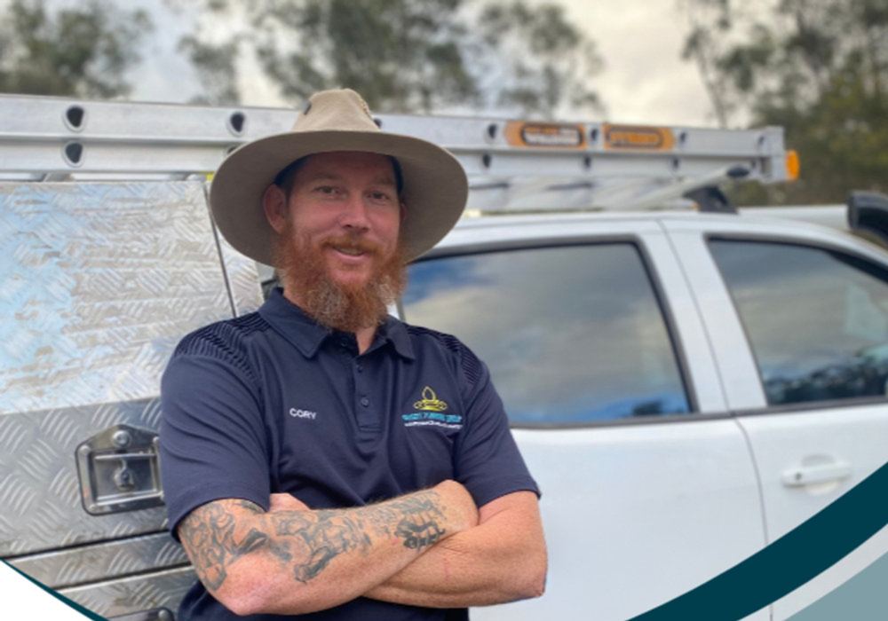 Cory from Bassett Plumbing Group standing beside the work ute