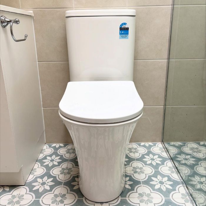 New toilet installed on patterned floor tiles