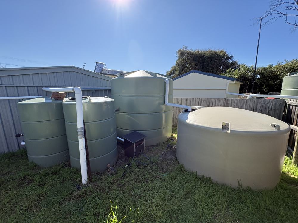 Group of rainwater tanks plumbed together with new stormwater lines