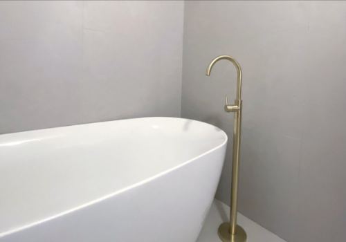 Freestanding bath with brushed brass tapware