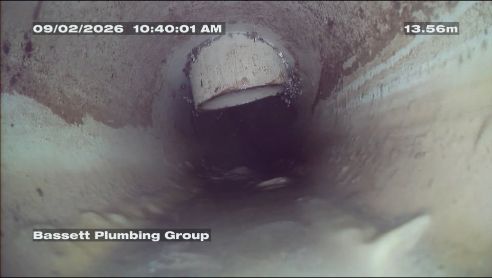 Camera footage inside a drain pipe, 13.56 metres along
