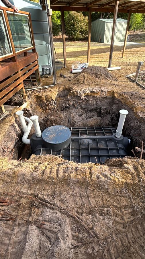 New septic tank being installed in an excavation