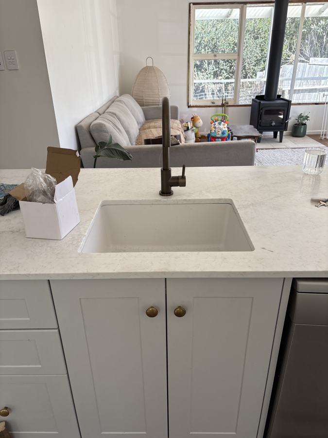 Bronze kitchen mixer on an undermount sink