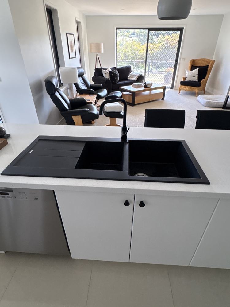 Black granite double sink with matte black mixer