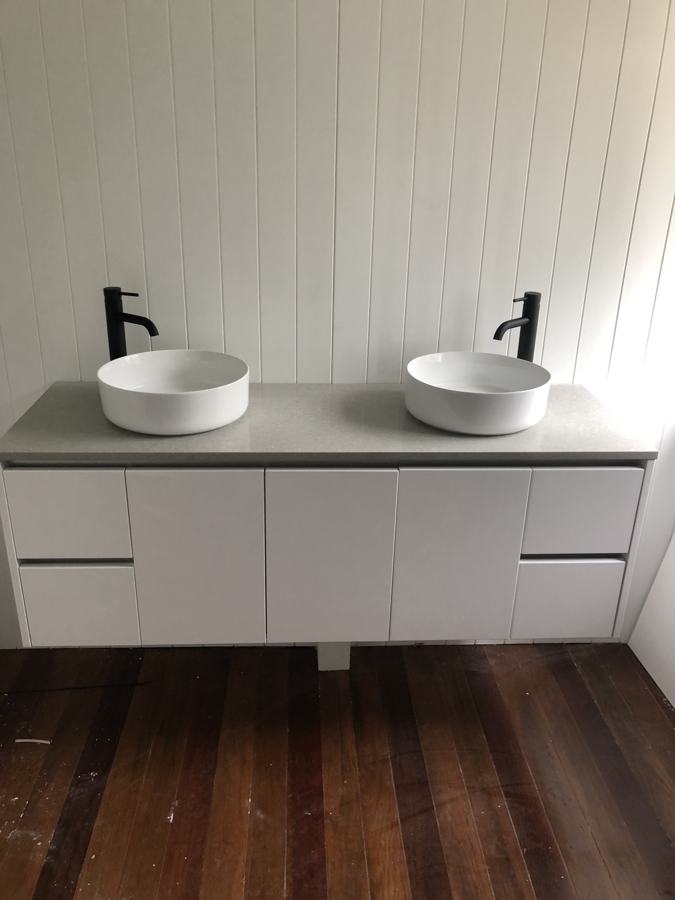 Double vanity with vessel basins and matte black mixers