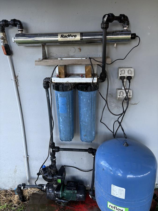 Before: The system we came out to: UV unit and twin filter housings on a tank and pump supply.