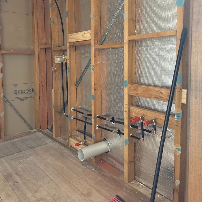 Bathroom rough-in with new pipework in the wall frame