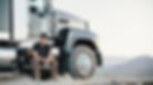 Man sitting in front of truck