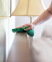 Wiping a bed headboard with cloth