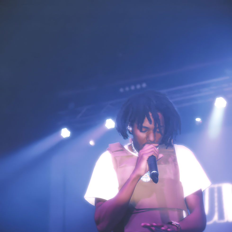 aura with the mic in his hand and auraverse in the back