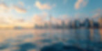toronto skyline from the water with gold, pink and blue tones during the day.jpg