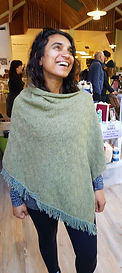 Real customer wearing Seashore textures poncho. Knitted with merino wool by Elizabeth Larsen Knitwear. Knitwear made in Scotland.