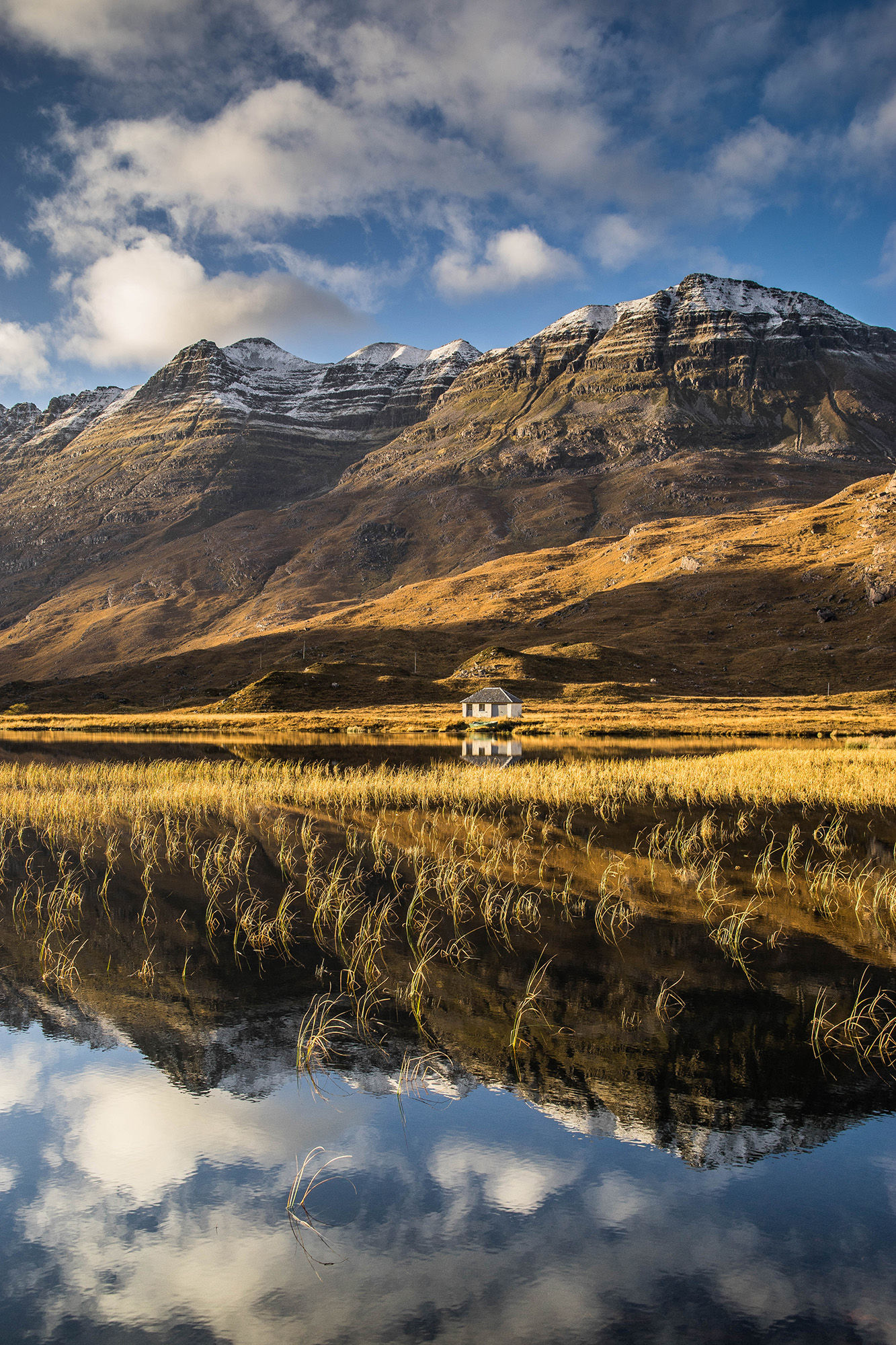 An autumnal Liathach reflecting into Lochan an Lasgair, Glen Torridon.