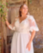 Close up front view of Envy by Phoenix PH7012 plus-size chiffon A-line wedding dress with lace illusion angel sleeve