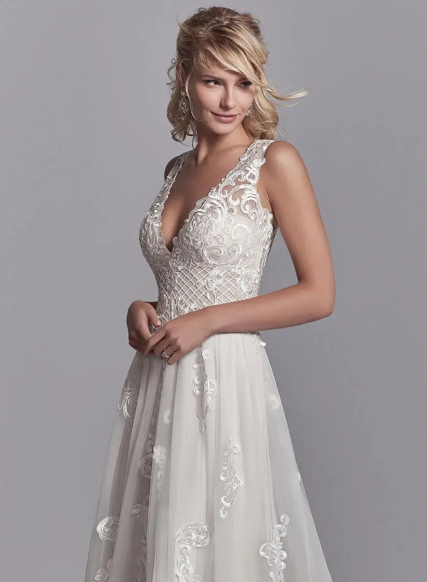 Thumbnail: Close up of Sottero and Midgley Oliver A-line wedding dress with oversized lace motifs and crosshatch detail