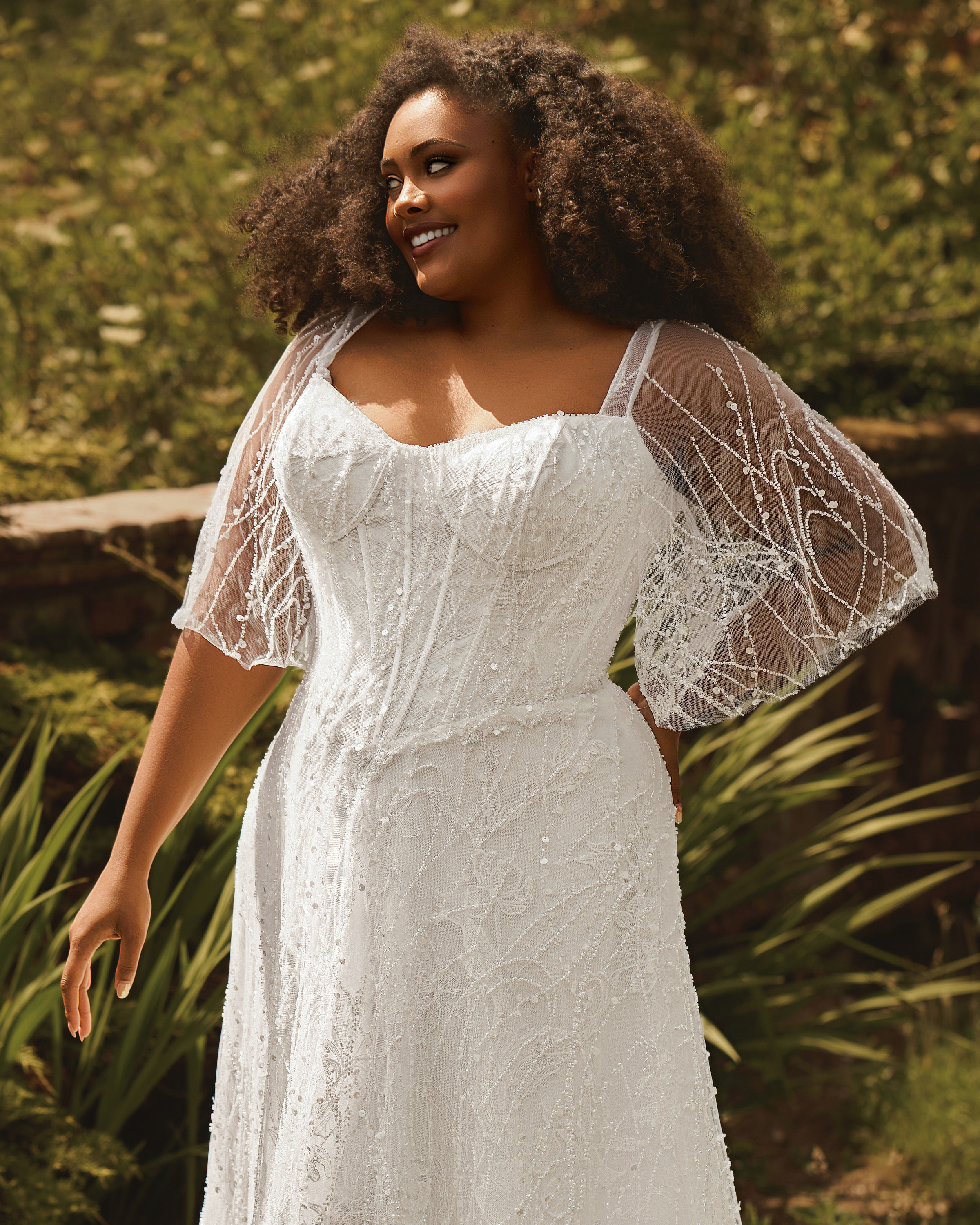 Close up front view of Phoenix by Envy PH8272 plus-size gentle A-line wedding dress with all over beadwork and sequins