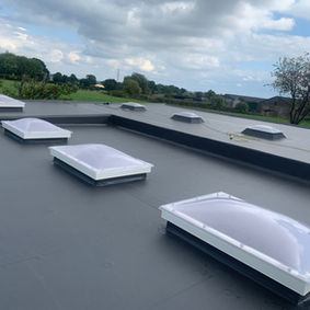 Modern flat roof installation with rooflights
