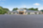 Lakeview building exterior with parking lot and trees.