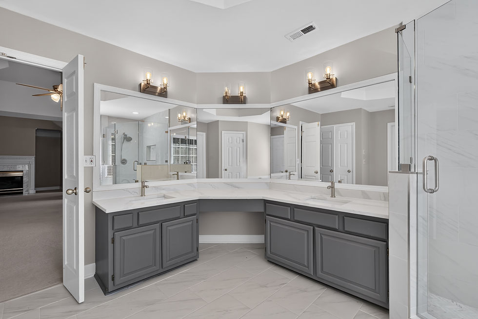 Modern gray bathroom vanity with marble countertop and large mirrors