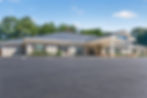 Single-story commercial building with paved parking lot