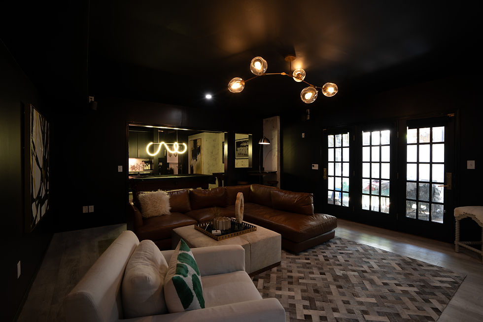 Modern dark living room with leather sectional and globe chandelier