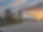 Modern warehouse exterior with loading docks at sunset.