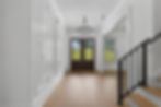 Atlanta real estate photography of a modern foyer with chandelier.