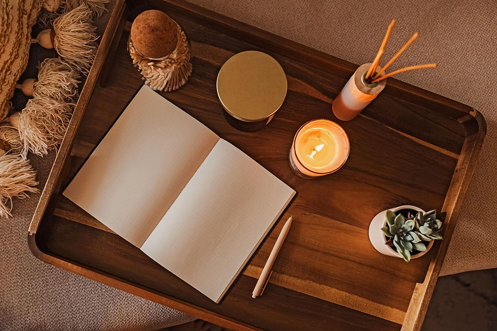 Cup of chamomile tea beside a journal and dried botanicals in soft evening light, representing a soothing de stress activity for winding down at home.