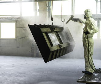 Worker Sandblasting Metal Piece