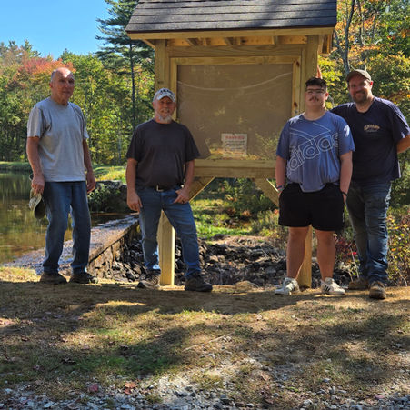Men standing in front of the informational kiosk at New City Pond