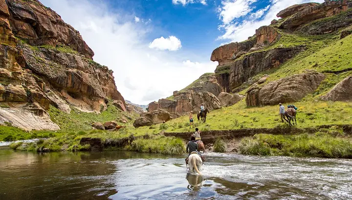 Riding through a river on horses