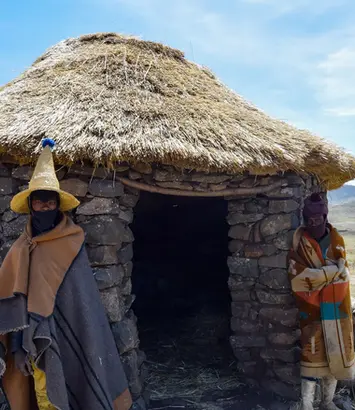 Two Baotho Men standing near hut in Lesotho