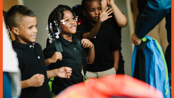 Children receiving backpacks 
