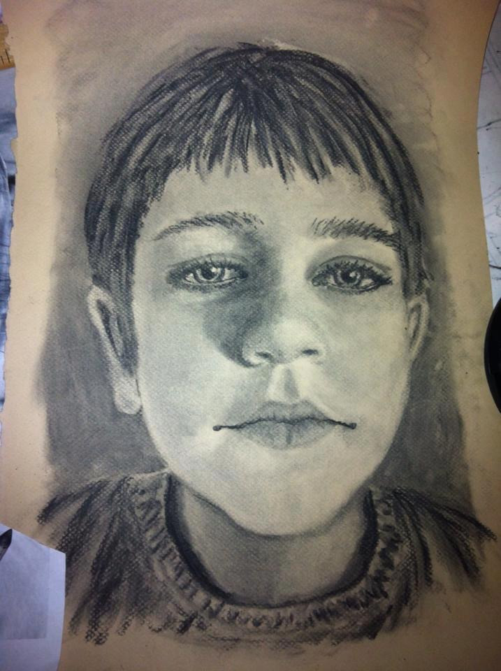 charcoal drawing of boy from shoulder up