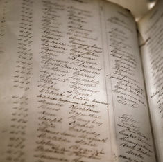 old book log showing names from a ship