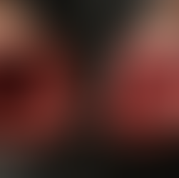 Hands covered in dripping blood, palms up, against a dark background, suggesting a dramatic or intense moment.