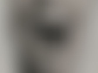 Black and white poster of a wide open mouth on a textured gray wall, conveying a sense of shouting or raw emotion.
