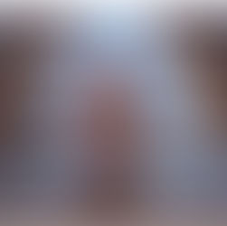 Man kneeling in prayer in a church aisle, wearing a gray shirt. Wooden pews line the aisle. Light filters through a door, creating a serene mood.