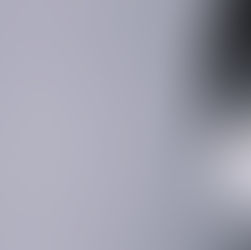 Young boy wearing a white face mask, partially visible against a plain light background. The image has a calm, muted tone.