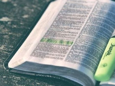 open Bible with highlighter and highlighted verses