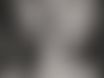 Close-up of a person holding a finger to their lips, signaling silence. Grayscale tones and soft focus create a calm, quiet mood.