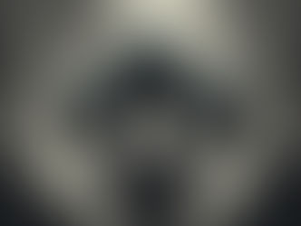 Three dark alien heads with elongated features and tangled roots emerge from a smoky, abstract background, creating an eerie atmosphere.