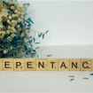 scrabble tiles spelling out repentance