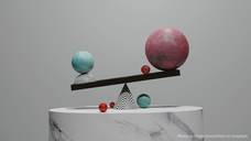 Balancing spheres on a seesaw: a large pink sphere and smaller teal one on a striped black and white surface. Red spheres scattered. Minimalist.
