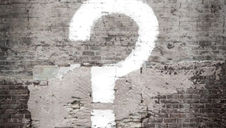 question mark painted on old brick wall