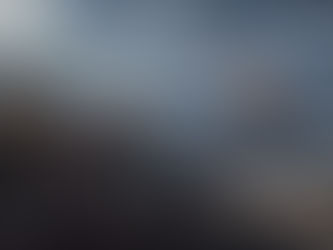 People in tribal attire stand on rocks, observing a distant glowing sphere and crowd across a vast landscape. Mountains and stormy sky loom. Text: "Cosmere Roleplaying Game," "Stormlight Campaign Setting."