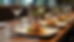 Eye-level view of a modern hotel restaurant table set with small, protein-focused dishes