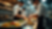Eye-level view of a busy restaurant kitchen with chefs preparing meals