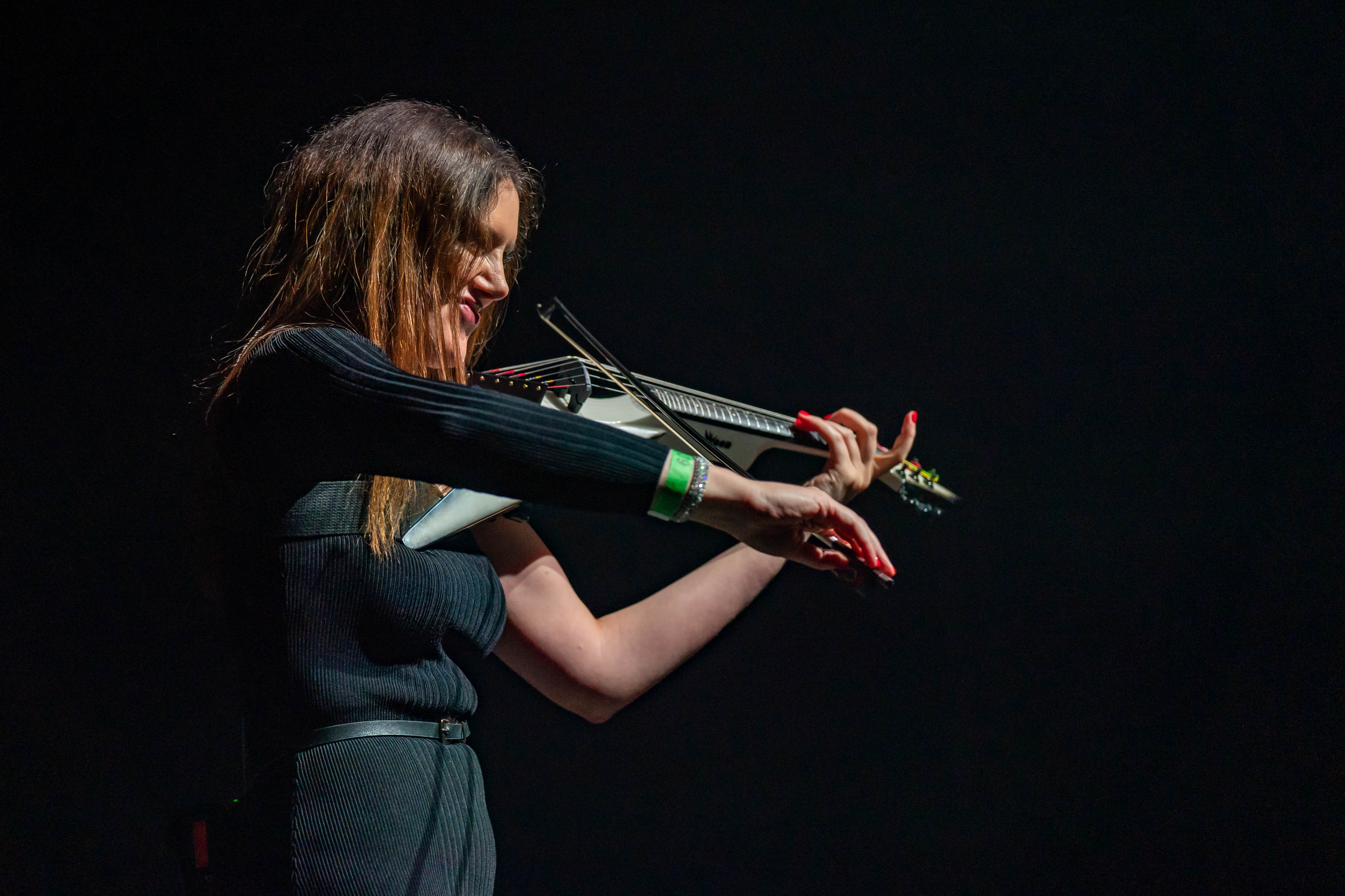 Katya Gabeli performing live with electric violin on stage